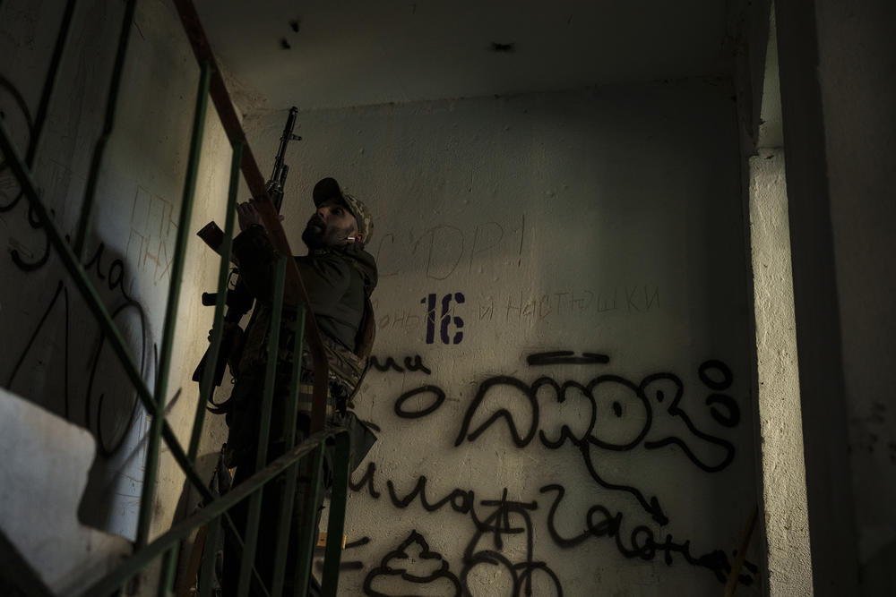 <strong>April 25:</strong> A Ukrainian serviceman walks in a building near a frontline position in Kharkiv.