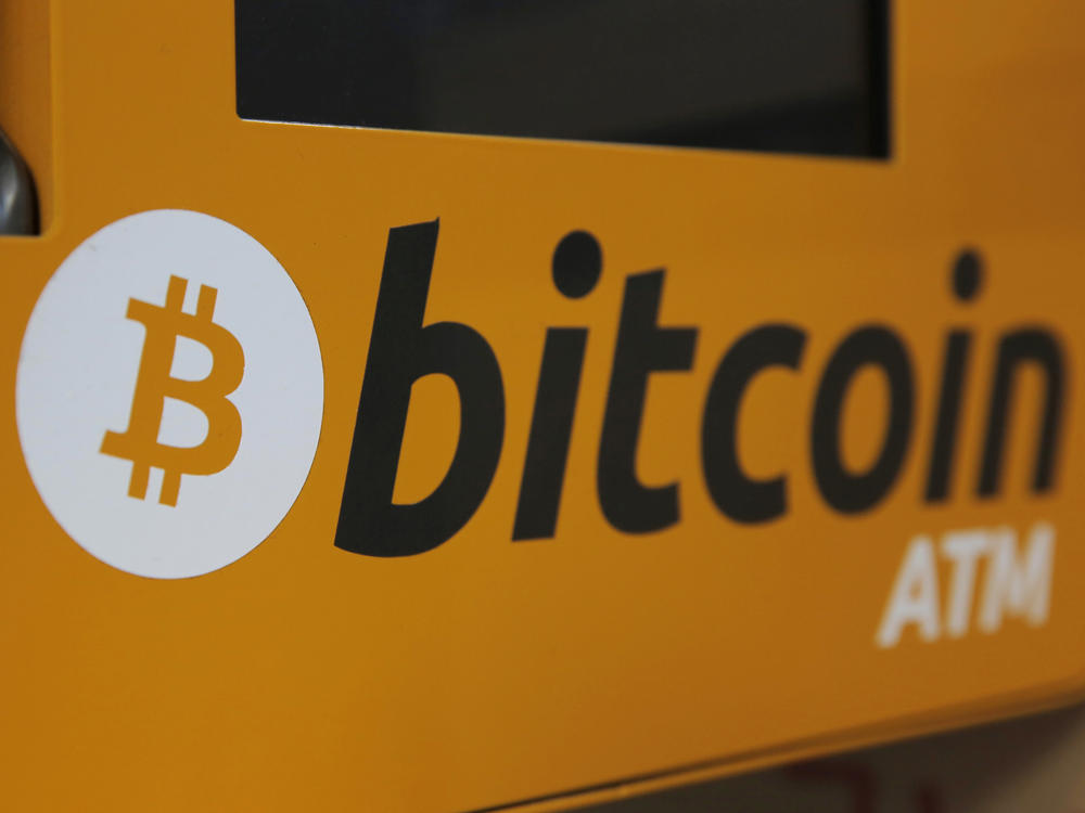 A Bitcoin logo is displayed on an ATM in Hong Kong in 2017. More workers may soon be able to stake some of their 401(k) retirement savings to bitcoin.