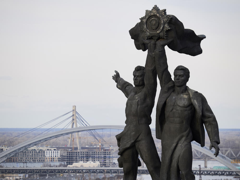 The statue under the People Friendship Arch in Kyiv, Ukraine, pictured on Feb. 23, 2022. It is being dismantled this week, but an altered version of the arch will remain standing.