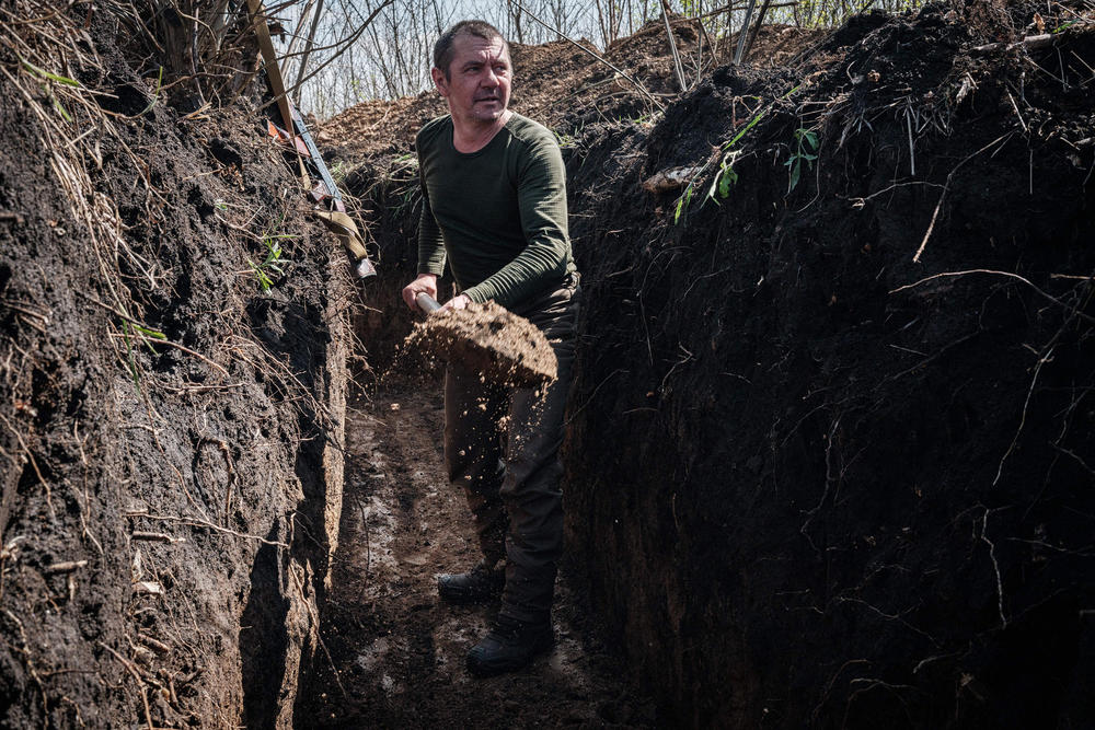 <strong>April 25:</strong> A Ukrainian serviceman digs a trench near Barvinkove, in eastern Ukraine.