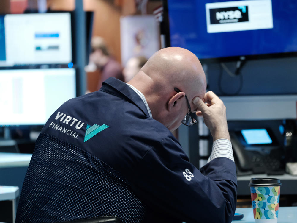 Traders work on the floor of the New York Stock Exchange (NYSE) in New York City on Monday. Stocks continued a recent sell-off over economic and earnings fears.