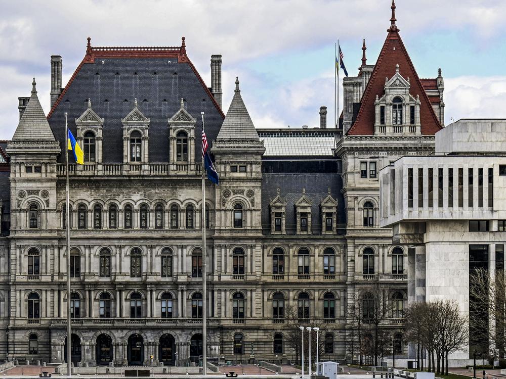 The New York state Capitol building (left) is shown next to the state appellate court building in foreground (right) on April 4 in Albany, N.Y.