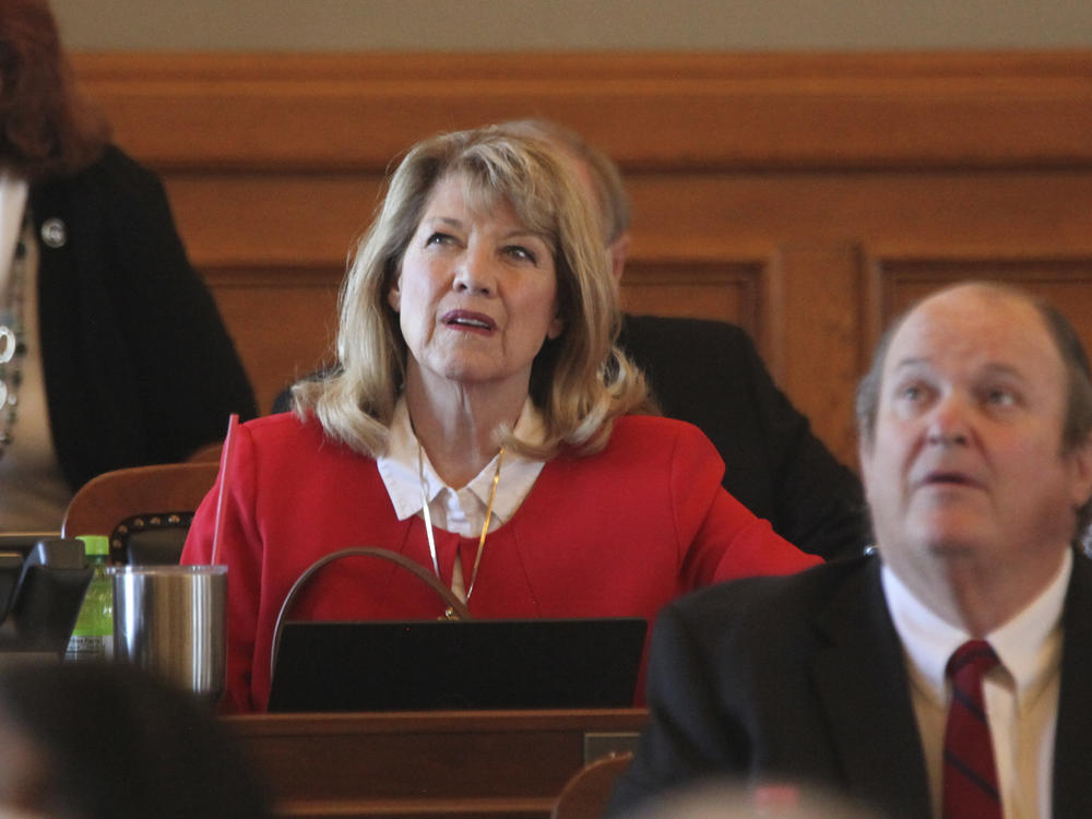 Kansas state Rep. Cheryl Helmer (center), R-Mulvane, watches one of the House's electronic tally board during vote on April 26 at the Statehouse in Topeka, Kan. Helmer has complained publicly about having to share women's restrooms with a transgender colleague.