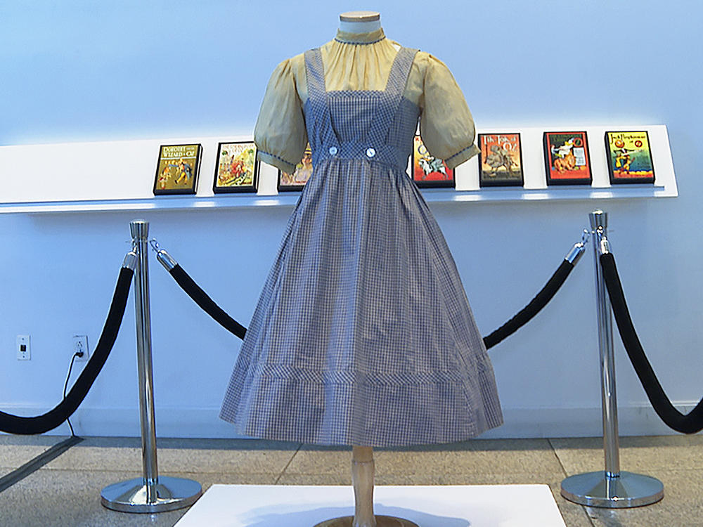 A blue and white checked gingham dress, worn by Judy Garland in <em>The Wizard of Oz,</em> hangs on display, Monday, April 25, 2022, at Bonhams in New York.