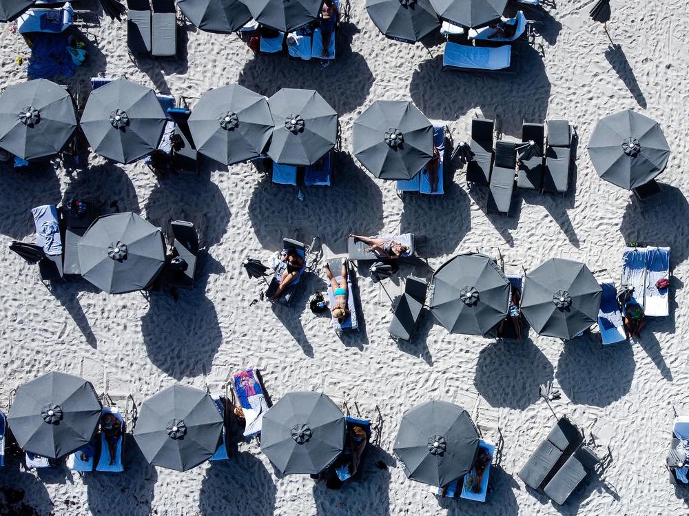 The U.S. economy likely slowed sharply in this year's first quarter, but conditions may be sturdier than they look as consumer spending remains healthy. Here, people relax in Sunny Isles Beach, Fla., on March 8.