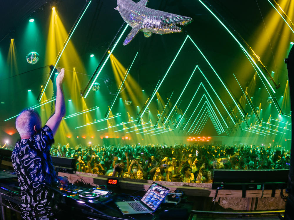 Fatboy Slim performs onstage at the Coachella Valley Music and Arts Festival in Indio, Calif., on April 24. Festivals and other gatherings are coming back despite the lingering COVID-19 pandemic.