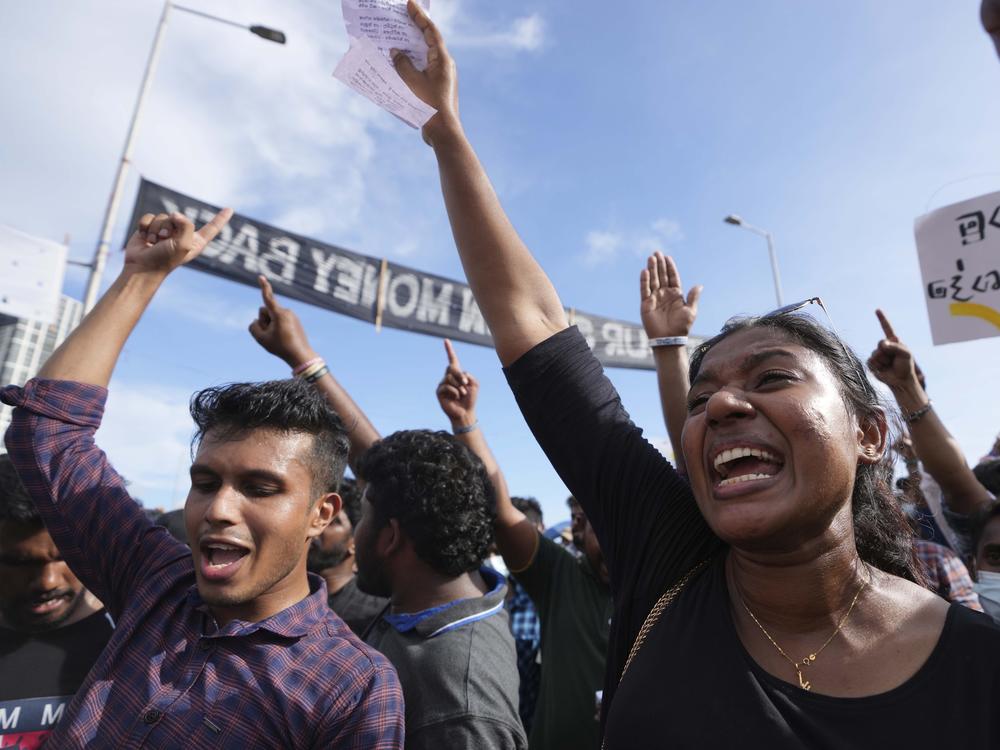 People shout slogans against the government during an ongoing protest outside president's office in Colombo, Sri Lanka, Saturday, April 23, 2022.