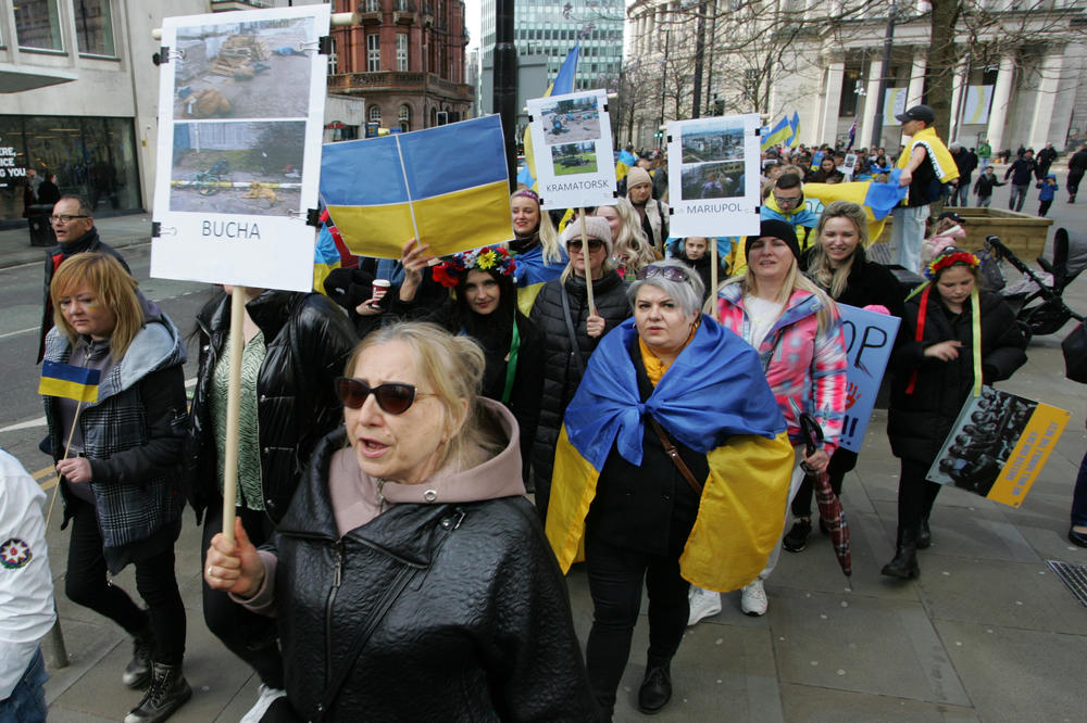 Ukrainian protesters in Manchester, England, hold placards on April 9 showing atrocities in Ukraine since the Russian invasion of the country.