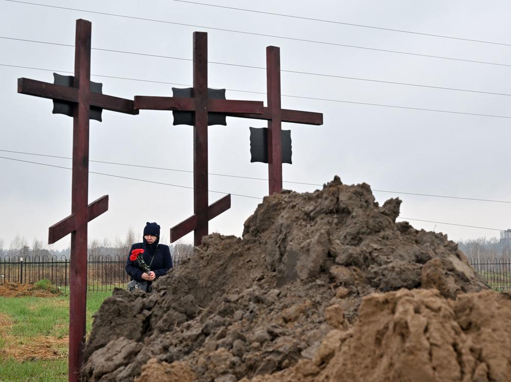 A mourner attends the funeral of a family of three in Bucha, on the outskirts of Kyiv, on Friday.
