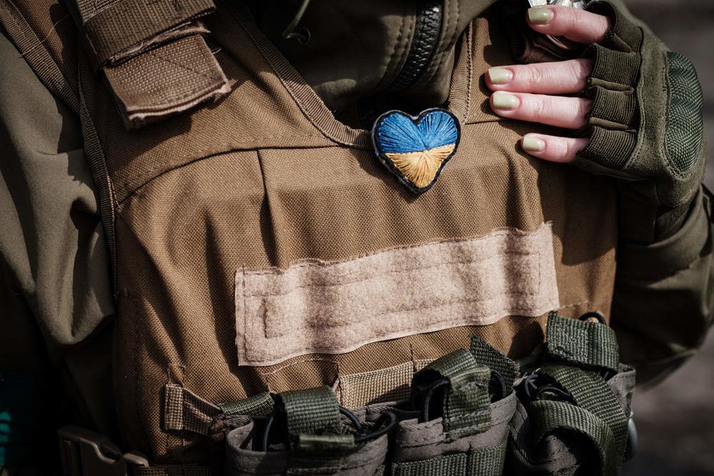 A Ukrainian soldier wears a heart-shaped Ukrainian flag given to her by a child at a checkpoint in Bakhmut, eastern Ukraine, on April 23.
