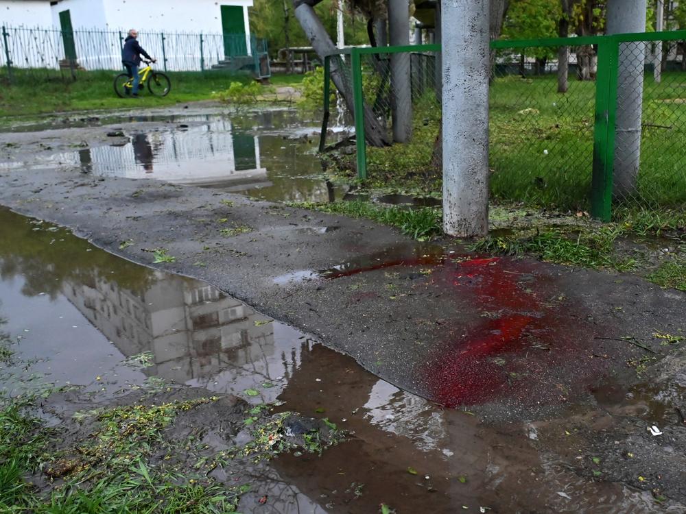 Blood is seen on a sidewalk in a residential area following shelling in Kharkiv, eastern Ukraine, on Wednesday.