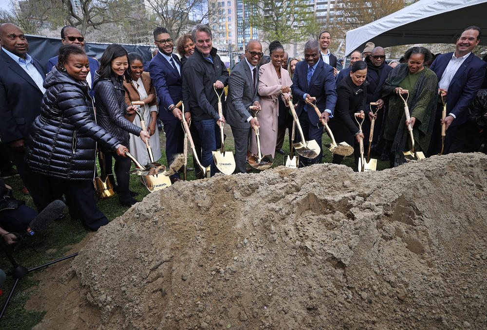 Officials, organizers and supporters participate in a groundbreaking ceremony for 
