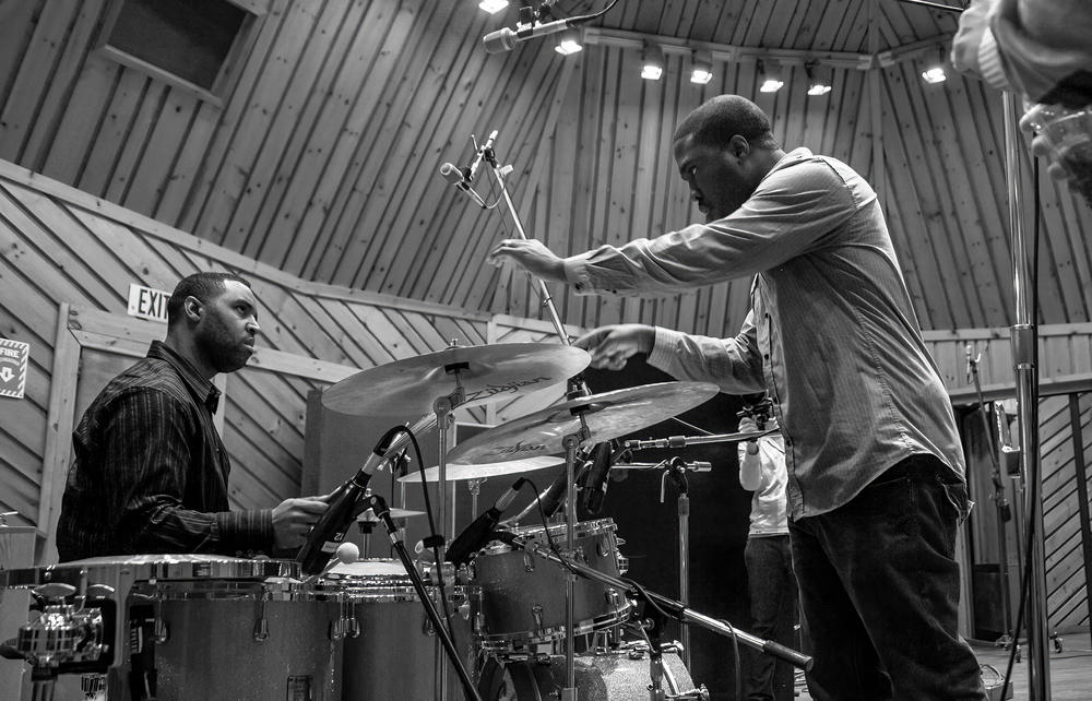 Producer Derrick Hodge conversing with Kendrick Scott, power station, for the album 
