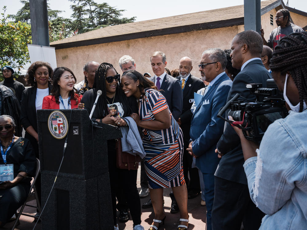 Shinese Harlins-Kilgore, cousin of Latasha Harlins and CEO of the Latasha Harlins Foundation, receives a hug from Lora King, daughter of Rodney King and CEO of the Rodney King Foundation, during the 30th anniversary of the Rodney King Civil Unrest HOPE Community Bus Tour Press conference in Los Angeles. Latasha, 15, was fatally shot in a liquor store.
