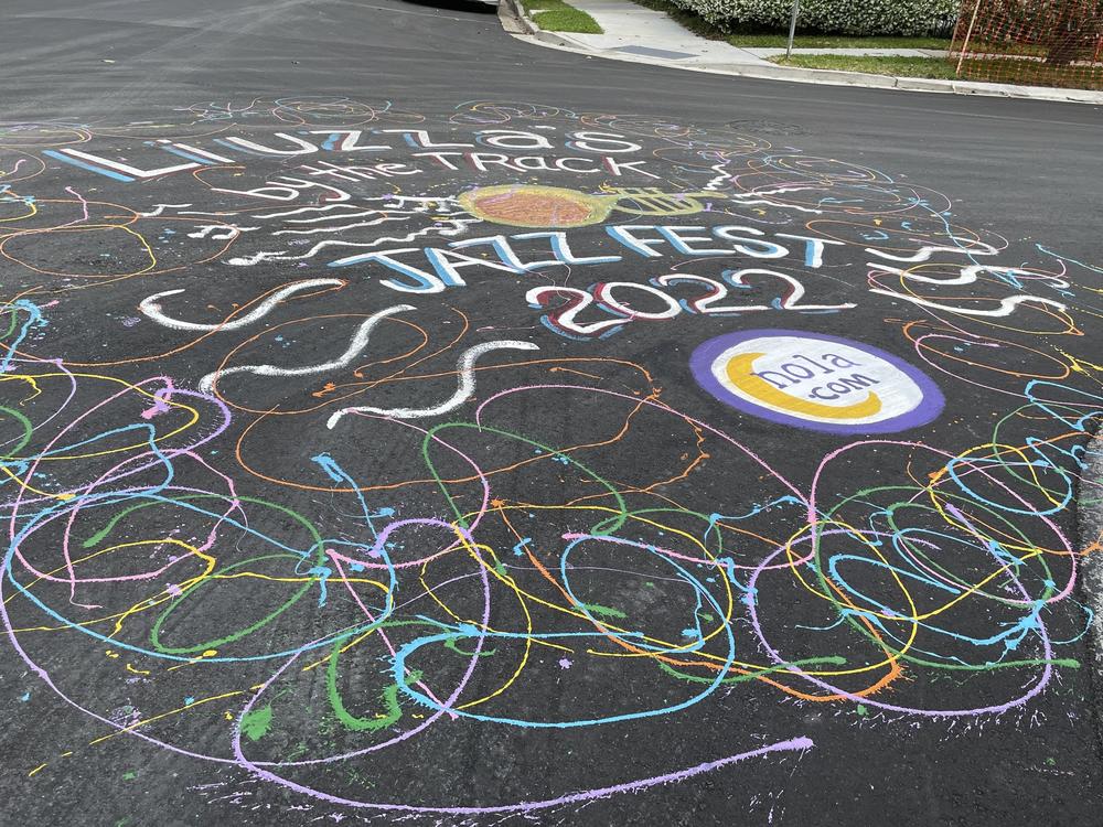 A freshly painted street mural outside Liuzza's by the Track in New Orleans on Tuesday, April 26, 2022, celebrates the impending return of the New Orleans Jazz and Heritage Festival.
