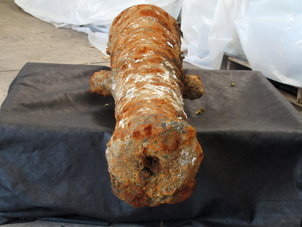 A cannon encrusted in rust and mud sits inside a warehouse operated by the Army Corps of Engineers in Savannah, Ga., on Thursday. It's one of 19 cannons discovered in the Savannah River since last year that experts believe date to the American Revolution.
