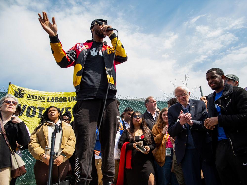 Amazon Labor Union leader Chris Smalls speaks next to U.S. Senator Bernie Sanders (I-VT) during a union rally outside an Amazon warehouse on Staten Island on April 24, 2022.