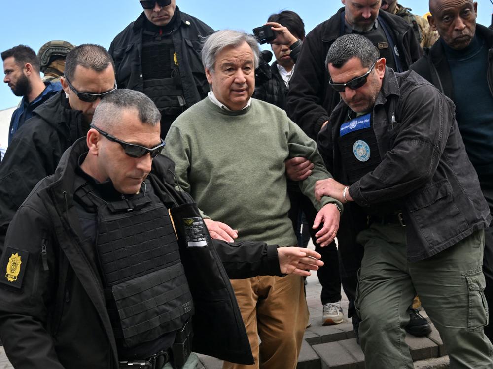 U.N. Secretary-General Antonio Guterres walks with security personnel as his visits Borodyanka, a town outside Kyiv that was devastated by a Russian attack and occupation, on Thursday. Russia sent a deadly attack into the capital as Guterres visited.