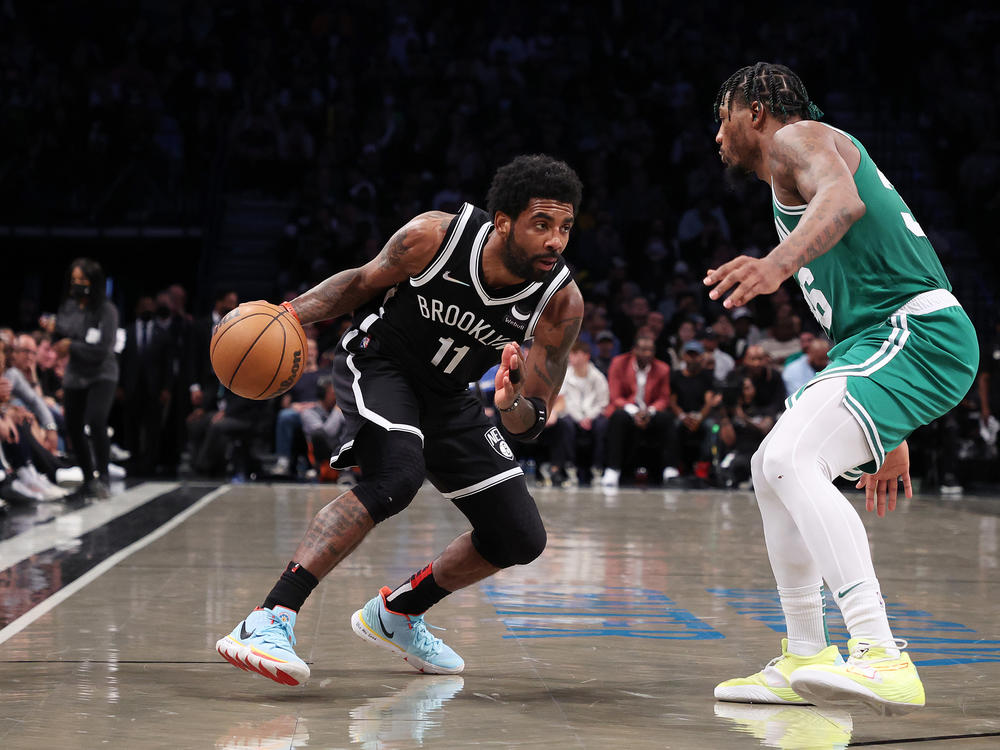 Kyrie Irving of the Brooklyn Nets drives against Marcus Smart of the Boston Celtics during Game 3 of the Eastern Conference first round in the 2022 NBA playoffs at Barclays Center.