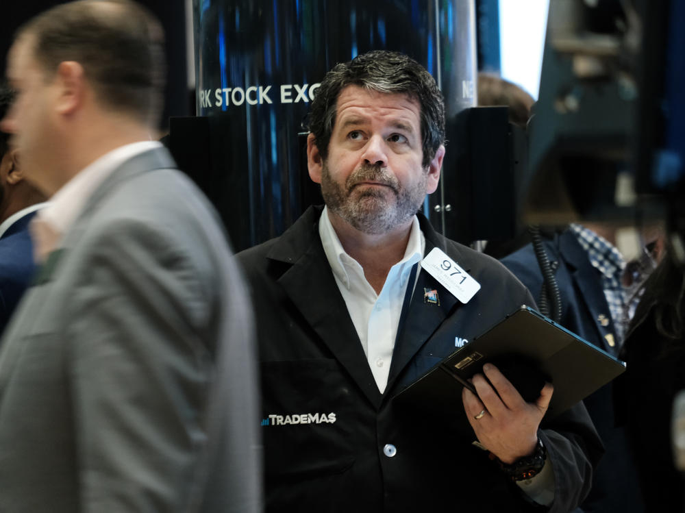 Traders work on the floor of the New York Stock Exchange (NYSE) in New York City on April 28. Stocks sank on Friday, ending a miserable month for Wall Street.