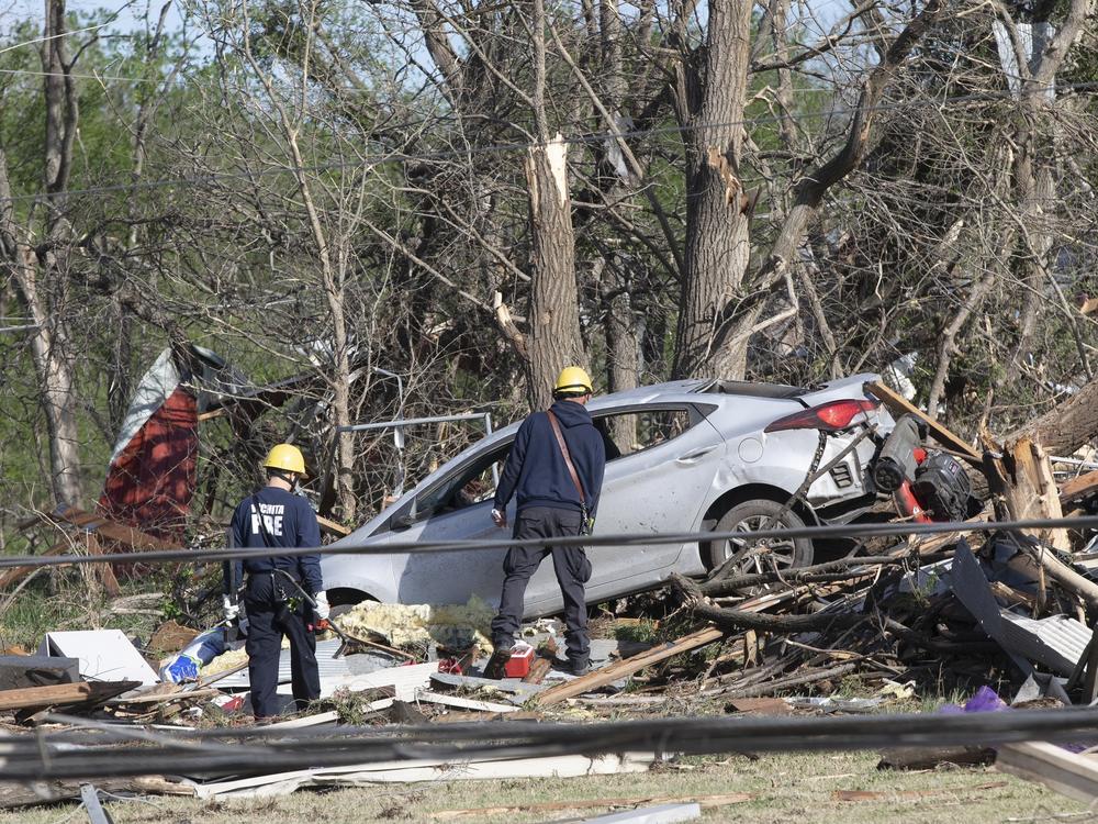Firefighters search what's left of John's Animal World on Saturday in Andover, Kan., after a suspected tornado hit the area.
