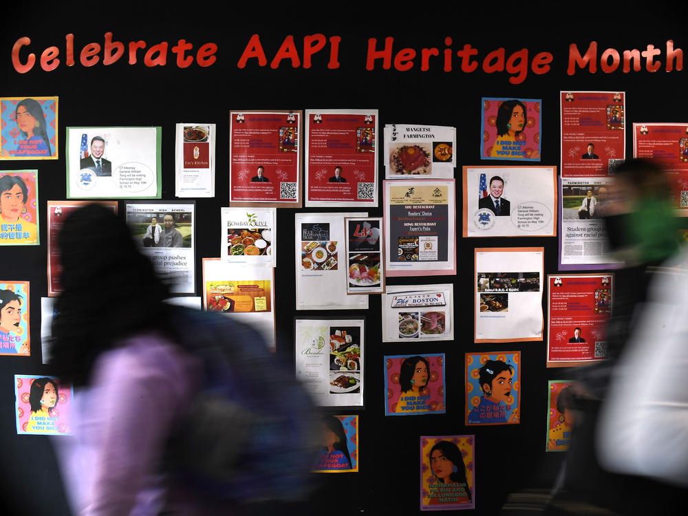 Students walk past a display for Asian Pacific American Heritage Month at Farmington High School in Farmington, Conn., on May 10, 2021
