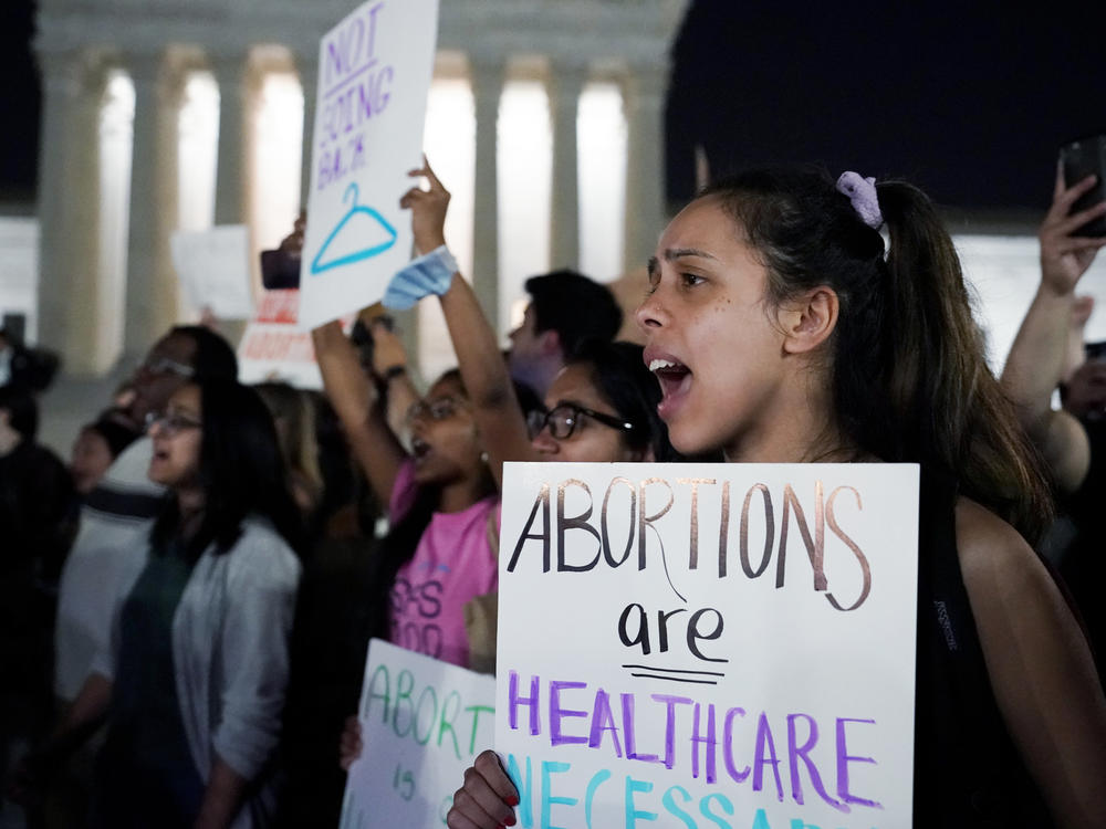 A crowd gathers outside the U.S. Supreme Court in Washington, D.C., early on Tuesday after a draft opinion was leaked indicating the court could strike down <em>Roe v. Wade</em>.