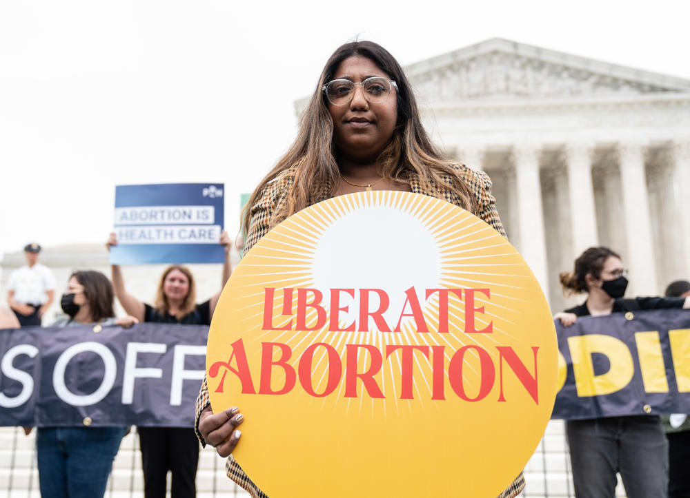 Sharmin Hossain, a Campaign Director for Liberate Abortion, stands with abortion-rights supporters outside the U.S. Supreme Court building Tuesday.