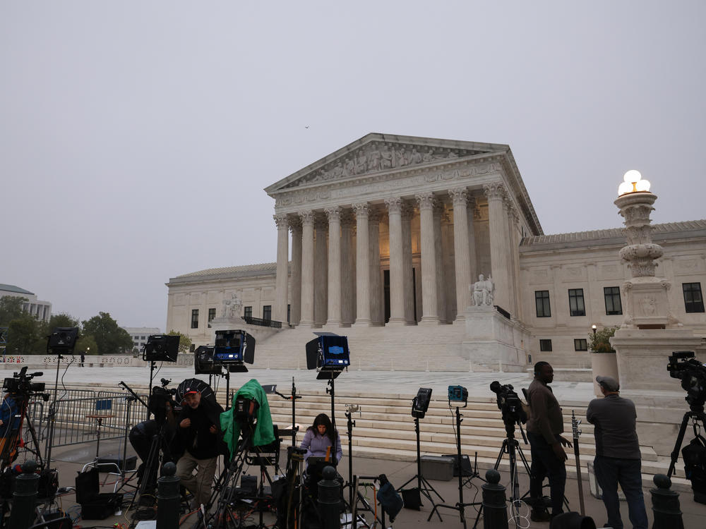 TV camera crews station in front of the Supreme Court building on Tuesday in Washington, D.C.