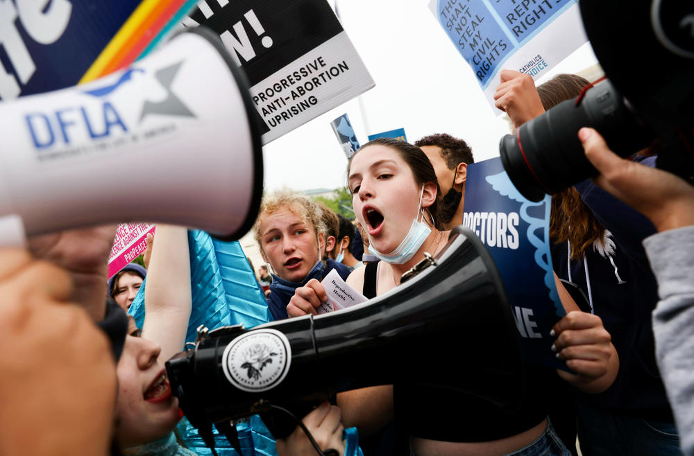 Protesters argue outside the U.S. Supreme Court building Tuesday after a leaked draft decision suggested a majority of the court's justices would vote to overturn <em>Roe v. Wade</em>.