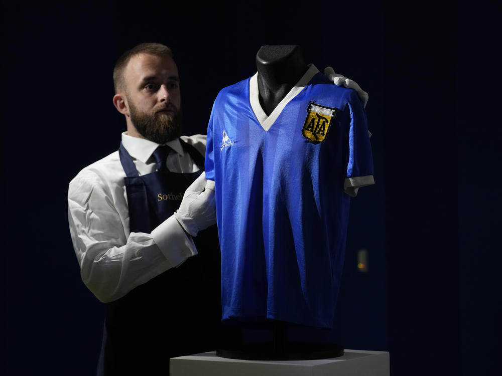 The Argentina football shirt worn by Diego Maradona in the 1986 Mexico World Cup quarterfinal soccer match between Argentina and England, is displayed for photographs at Sotheby's auction house, in London, on April 20. The shirt worn by Maradona when he scored the controversial 