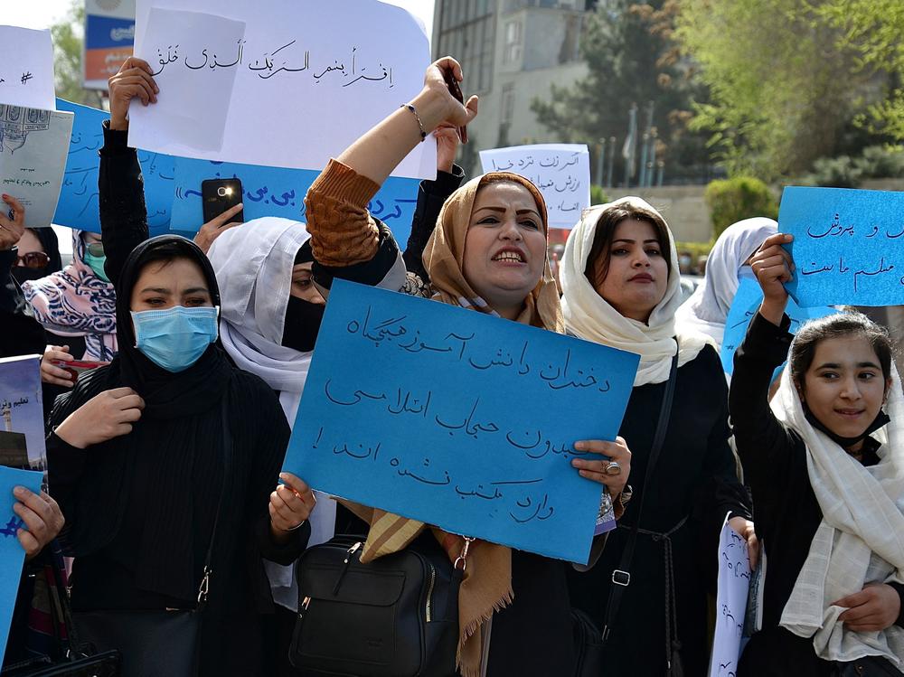Afghan girls and women and girls protest in front of the Ministry of Education in Kabul on March 26, 2022, demanding that high schools be reopened for girls.
