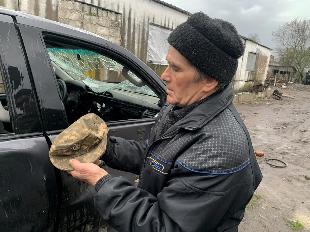 Anatolii Kulibaba, 70, holds his son Oleksandr's hat near his destroyed truck last month in Bilka, Ukraine. His son was killed by Russian forces early in the war.