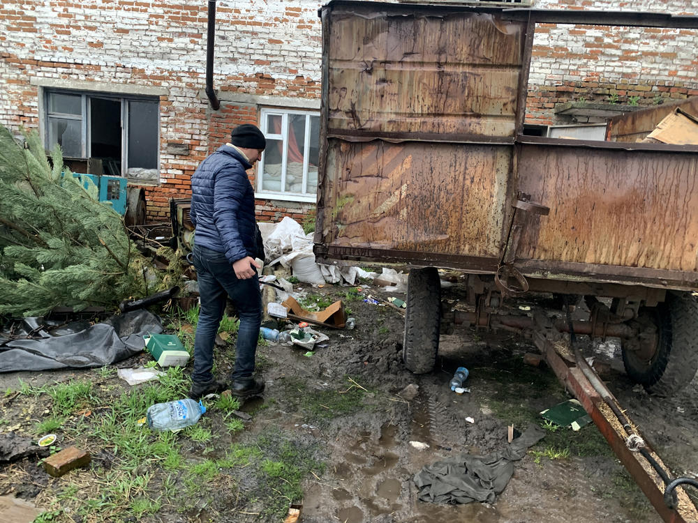 Valeria Kyselov, 36, walks past discarded meal packs near the barn where Russian soldiers slept in Bilka, Ukraine.