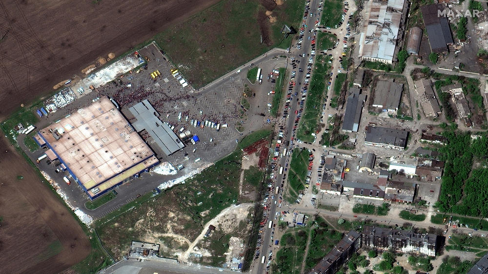 People wait for supplies outside a shopping center in Mariupol, in a commercial satellite image taken April 29.