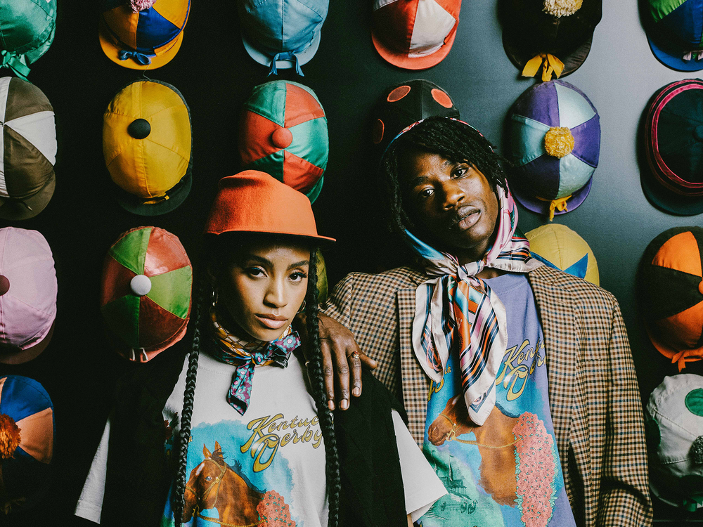 Models pose in pieces alongside a display of hats from Homme + Femme's newest collaboration with Churchill Downs, the horse racing complex that is home to the Kentucky Derby.