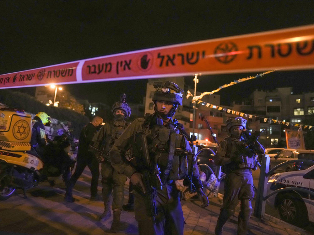 Israeli forces secure the area of a stabbing attack in the town of Elad, on Thursday. Israeli medics say at least three people were killed.
