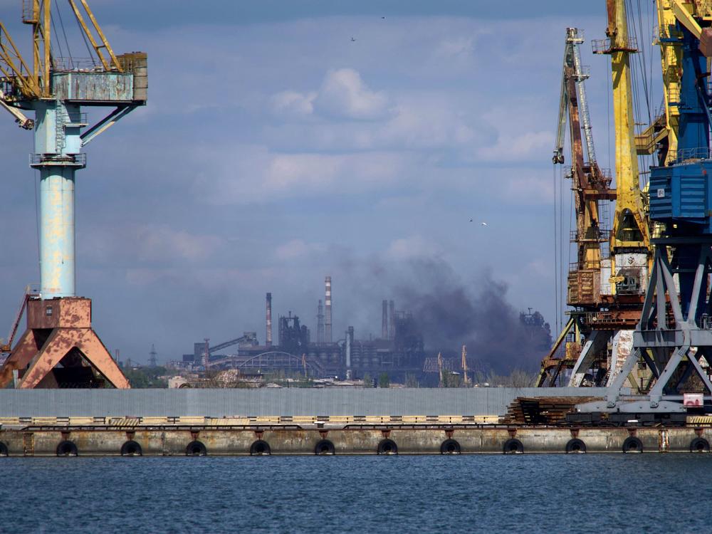 Smoke rises above the Azovstal steel plant in Mariupol on April 29, amid Russia's invasion of Ukraine. Hundreds of civilians are still trapped inside, officials say.