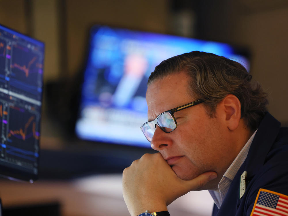 Traders work the floor of the New York Stock Exchange in New York City on Thursday. Stocks fell sharply a day after the Federal Reserve raised interest rates by the most in over two decades.