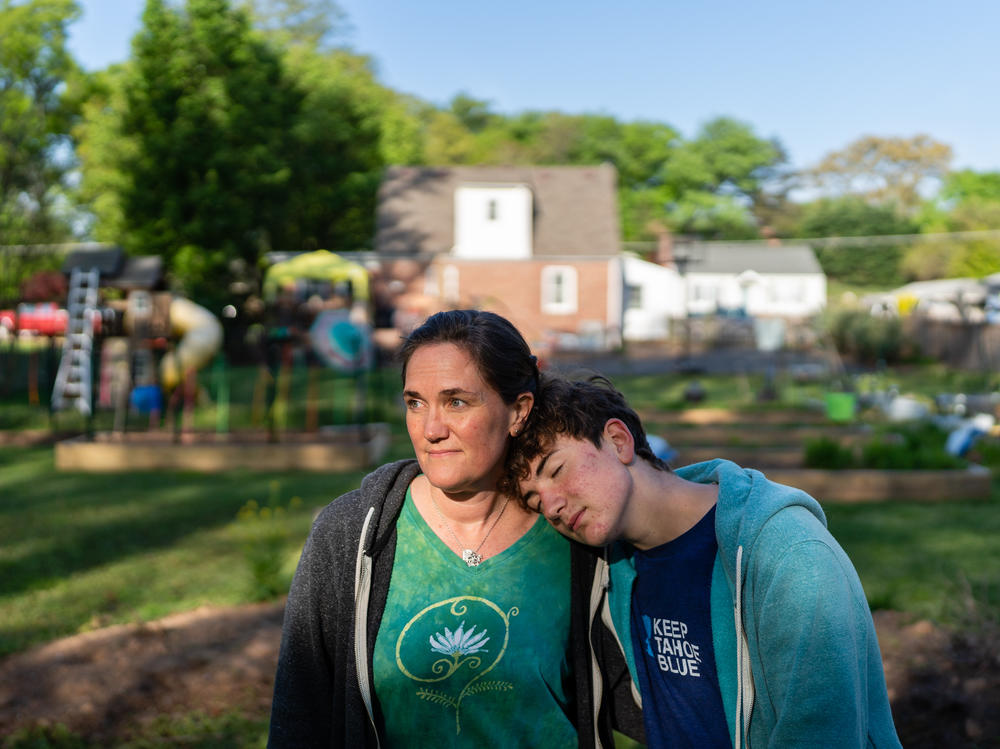 Jenna Fournel and Leal Abbatiello, 14, pose for a portrait at their home in Alexandria, Va. on April 30, 2022. Since the start of the pandemic in 2020, Fournel and her son expanded their garden and began harvesting and giving away produce for free to their community.
