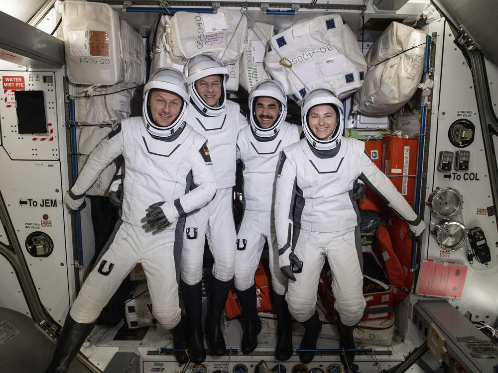 In this photo made available by NASA, commercial crew astronauts, from left, European Space Agency astronaut Matthias Maurer, and NASA astronauts Tom Marshburn, Raja Chari, and Kayla Barron, pose for a photo in their Dragon spacesuits during a fit check aboard the International Space Station's Harmony module on April 21, 2022.