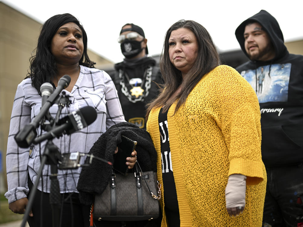 Katie Wright (center) stands beside activist Toshira Garraway and her son, Damik Bryant, during a news conference on Thursday outside a police station in Brooklyn Center, Minn. Katie Wright, the mother of Daunte Wright, said she was injured while she was briefly detained by one of the same department's officers after she stopped to record an arrest of a person during a traffic stop.