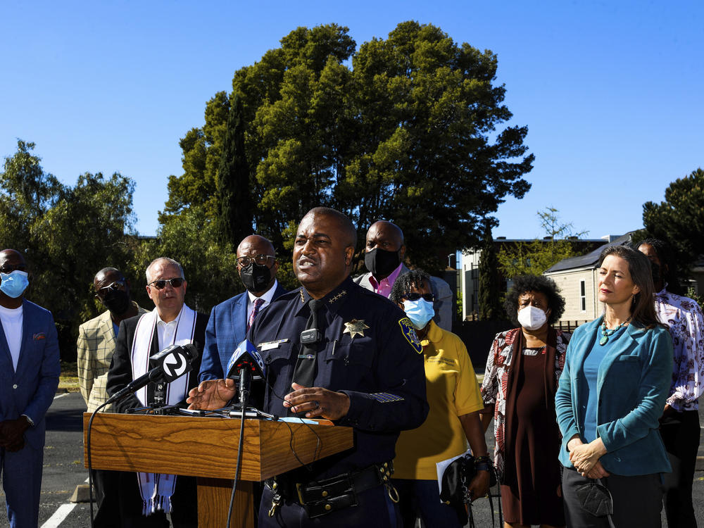 LeRonne L. Armstrong, Chief of Police, Oakland Police Department, stands near Oakland Mayor Libby Schaaf, right, as he delivers remarks during a press conference in Oakland, Calif.