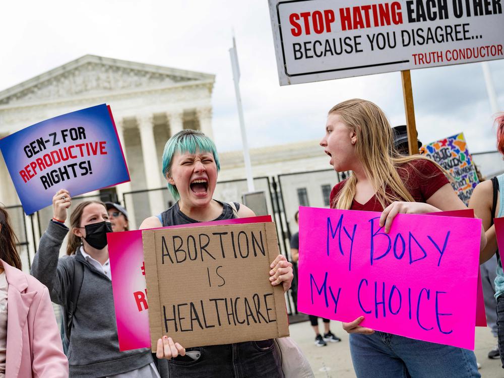 Young people who support access to abortion chant in front of un-scalable fence that stands around the US Supreme Court in Washington, DC, on May 5, 2022.