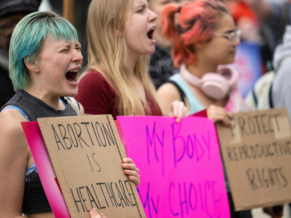 Abortion-rights supporters chant Thursday in front the Supreme Court building.