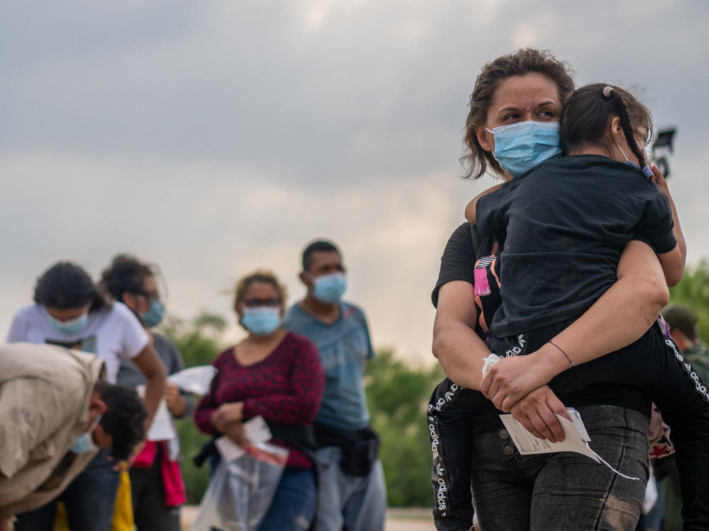 Migrants in La Joya, Texas, on Tuesday wait to be processed after crossing the Rio Grande into the United States.