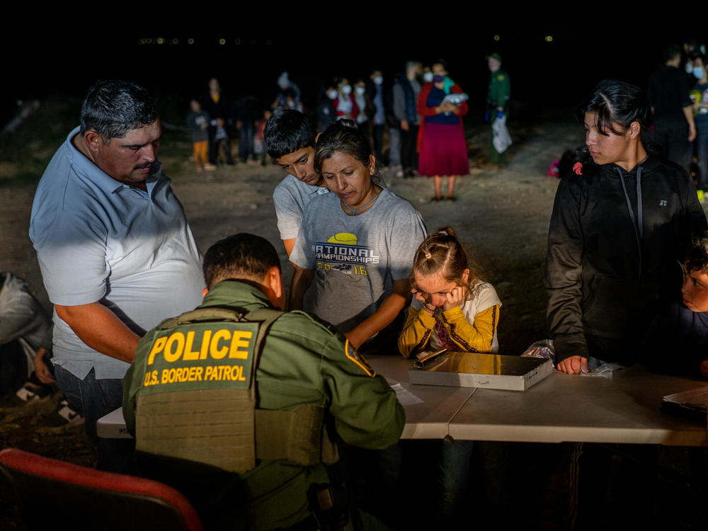 Border Patrol officers in Roma, Texas, on Thursday process a migrant family after the family crossed the Rio Grande into the United States.