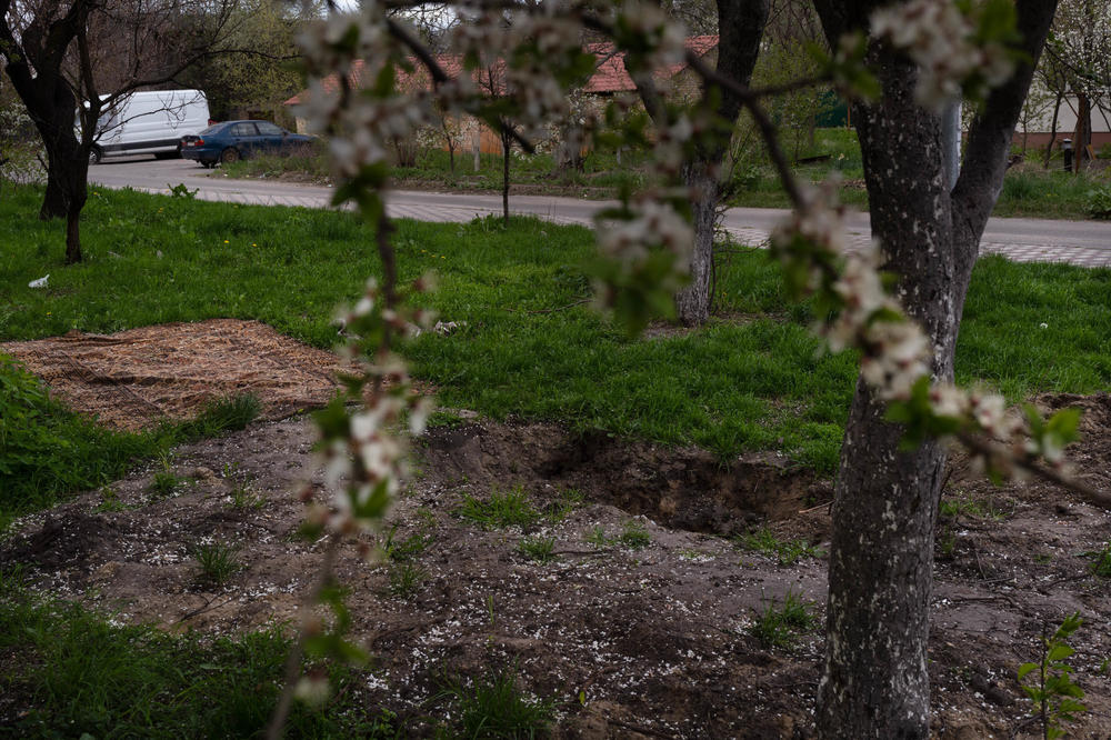An empty grave outside a residential building in Bucha, a suburb of Kyiv. A body was removed from the grave after Russian forces withdrew from the area.