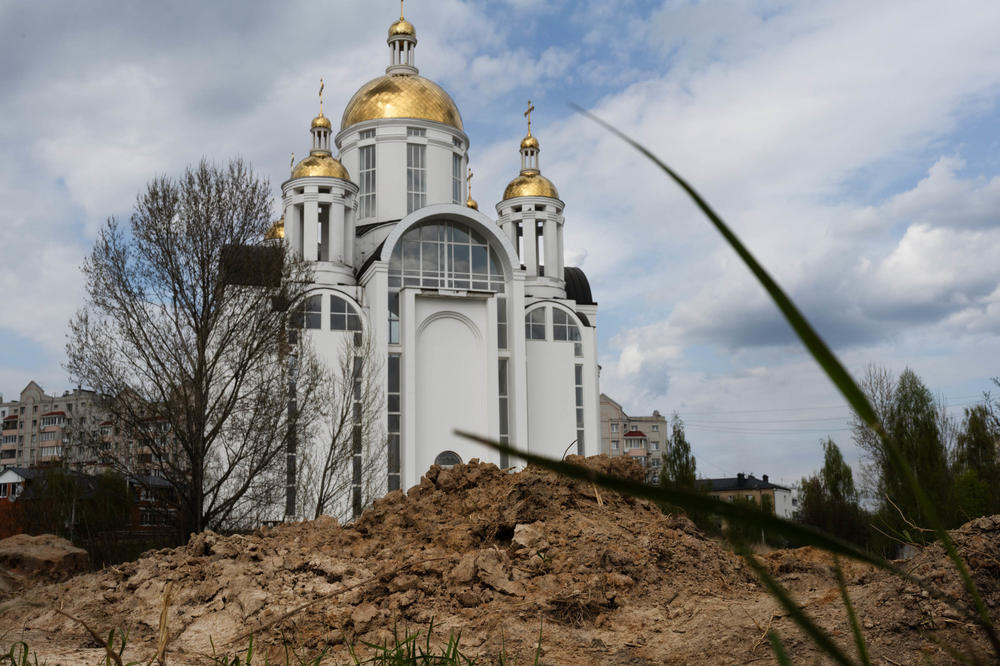 Dirt is piled in front of the Church of St. Andrew and Pyervozvannoho All Saints, in Bucha, a suburb of Kyiv, where a mass grave was found. Bodies were found in the grave and removed after Russian forces withdrew from the area.