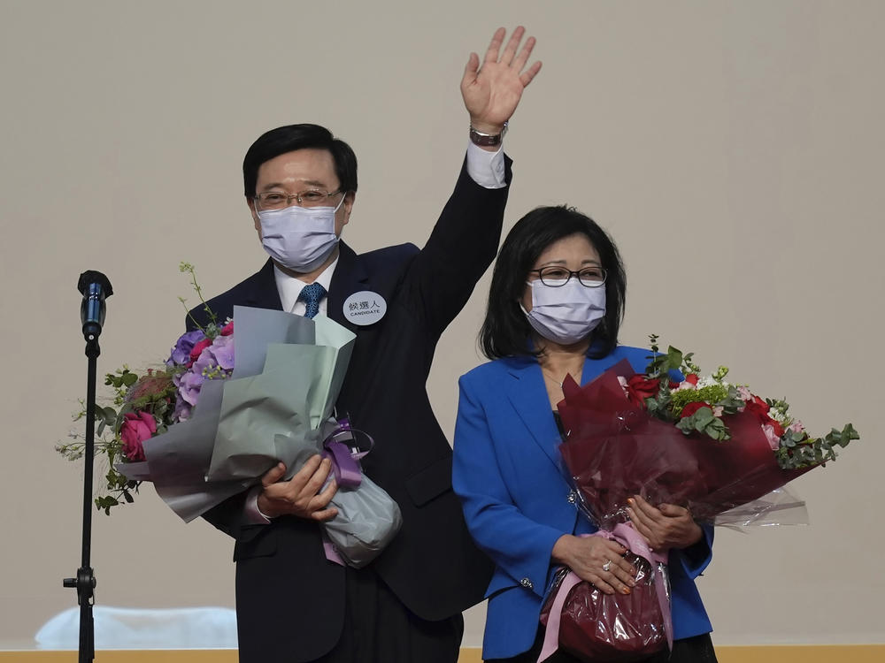 John Lee, former No. 2 official in Hong Kong and the only candidate for the city's top job, celebrates with his wife after declaring his victory in the chief executive election of Hong Kong in Hong Kong, Sunday, May 8, 2022.